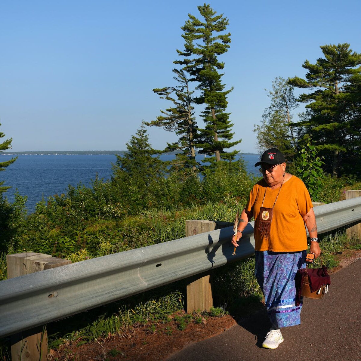  Indigenous advocate Sharon Day, leader of the Lake Superior Nibi Walk, carries the water pail near Bayfield, Wis. “We have never spilled the water, and we are never going to spill the water,” she said of her 20 years of walks. Photo by Anthony Souffle, Star Tribune.