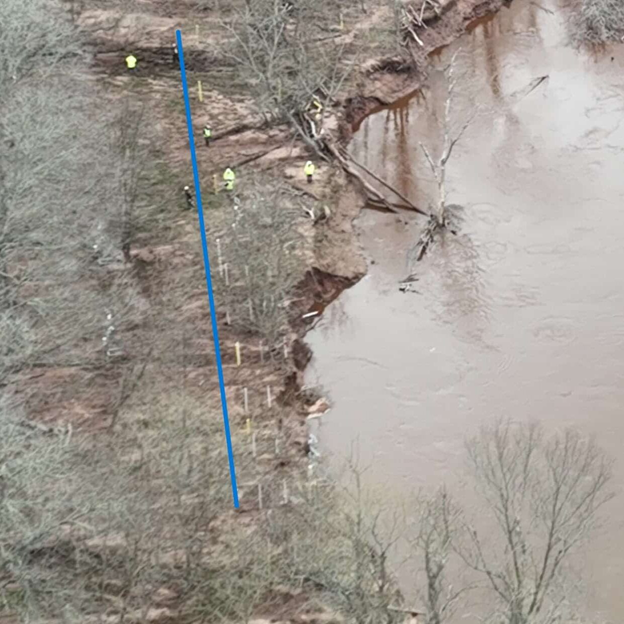 Still image from David Joe Bates’ drone footage taken May 14, 2023, showing Enbridge workers on the Line 5 pipeline site. The Mashkiiziibii (Bad River) riverbank is quickly eroding toward the active, decrepit pipeline, just 16 miles upstream from Lake Superior. 